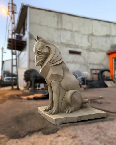Geometric wolf sculpture in sitting position on stone column gate entrance